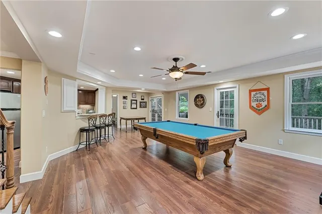 a room with furniture pool table and windows