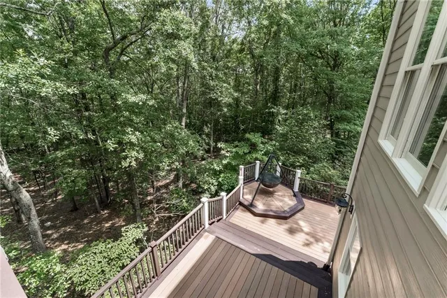 an aerial view of residential house with outdoor space and trees all around