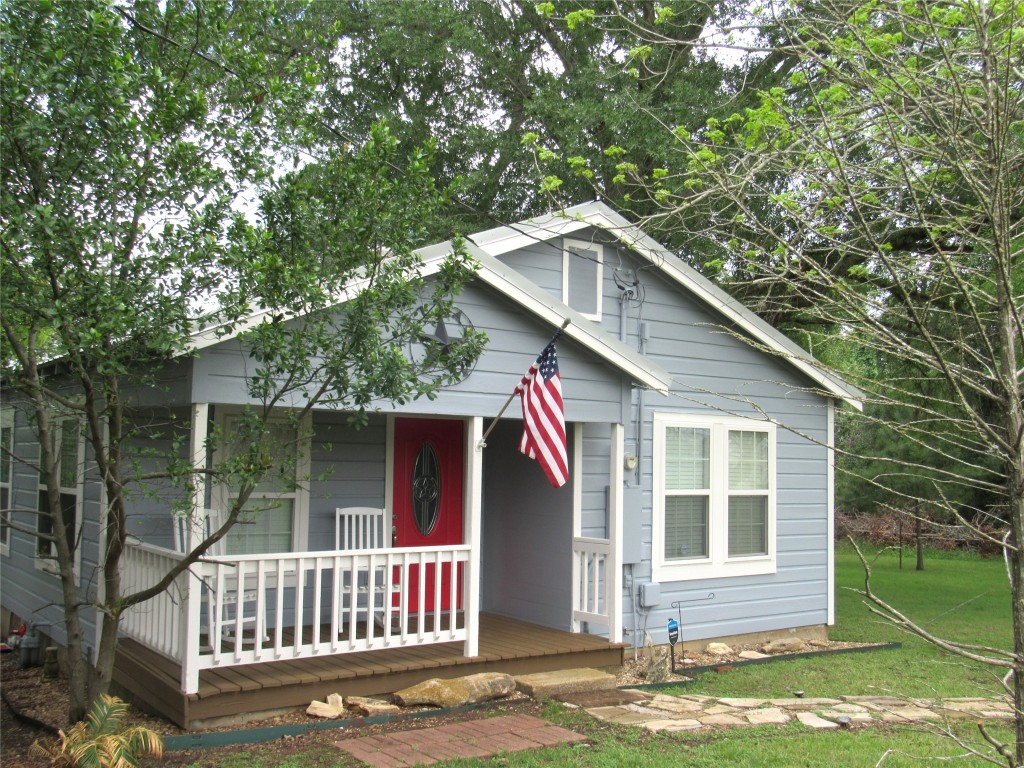 1013 Prairie Lea Street Brenham, TX 77833 - Photo 1 of 36 a front view of a house with a garden