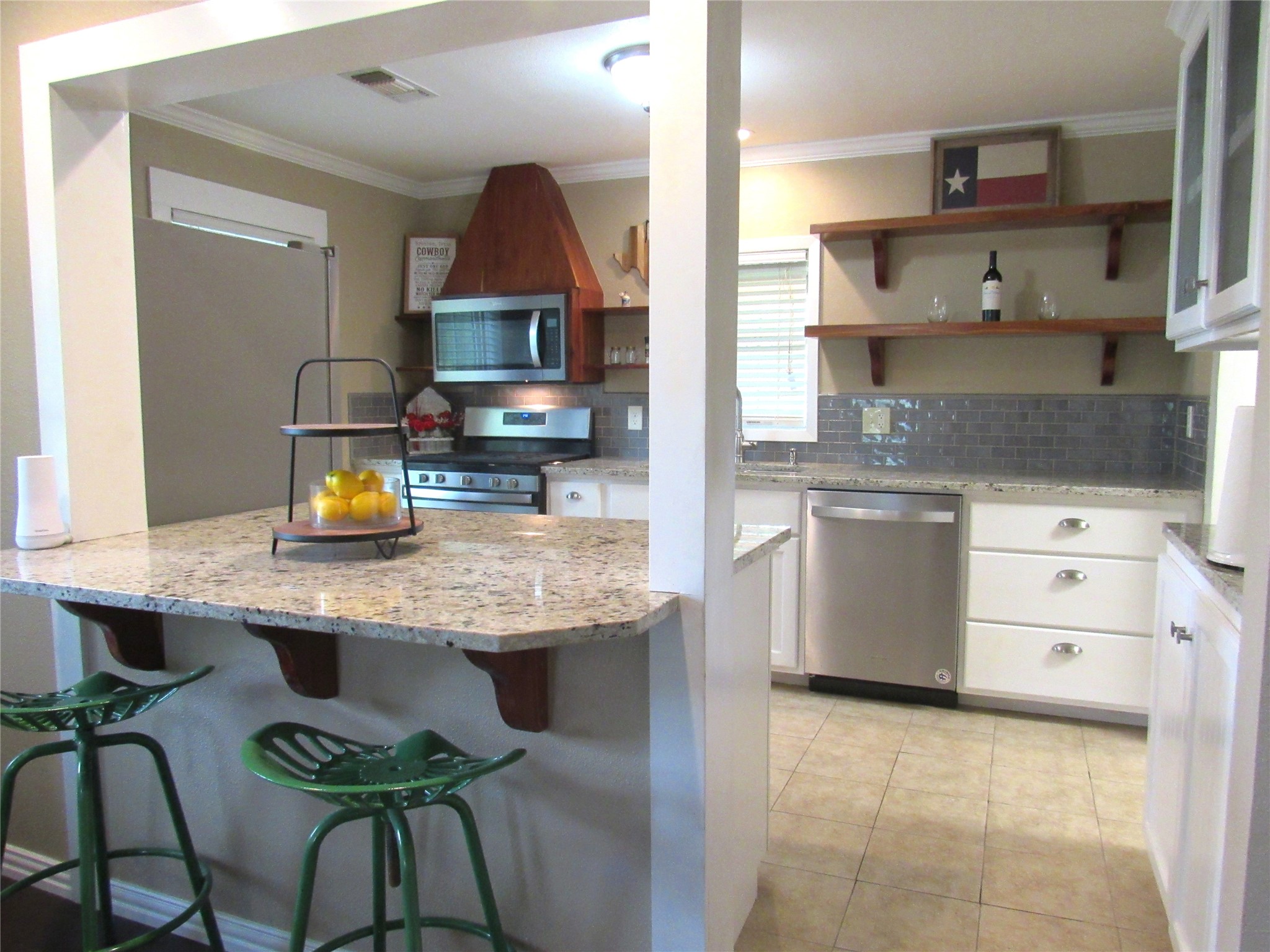 1013 Prairie Lea Street Brenham, TX 77833 - Photo 8 of 36 a kitchen with stainless steel appliances granite countertop a table chairs sink and cabinets