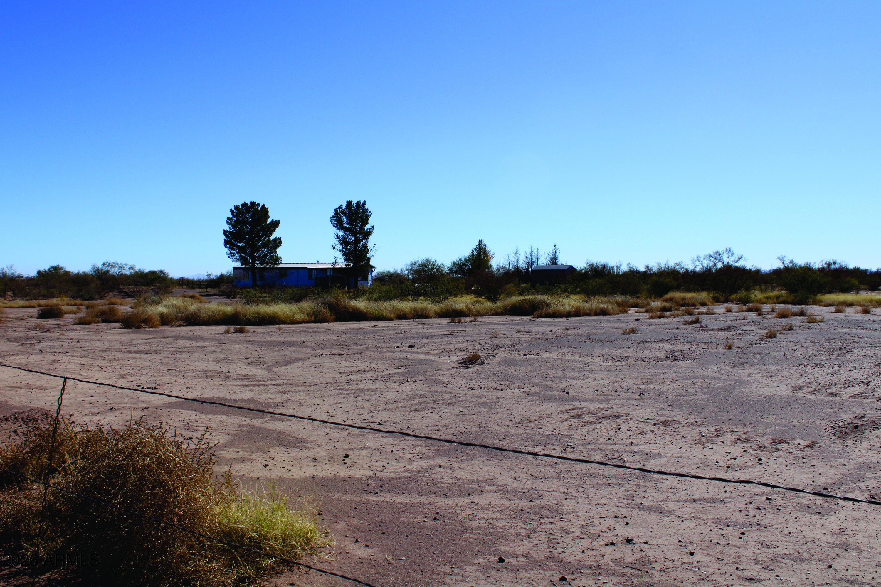 4.49-acres West Duke Road, Unit 2 McNeal, AZ 85617 - Photo 17 of 26 a view of a dry yard with wooden fence