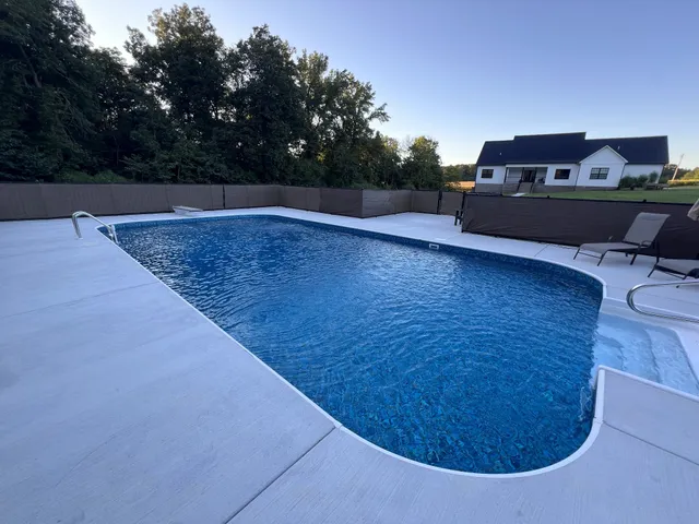 a living room with furniture a clock and a fireplace