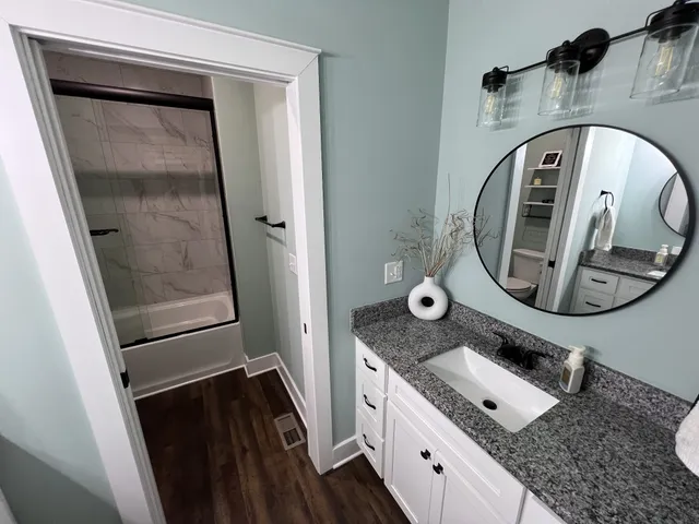 a white toilet sitting next to a shower