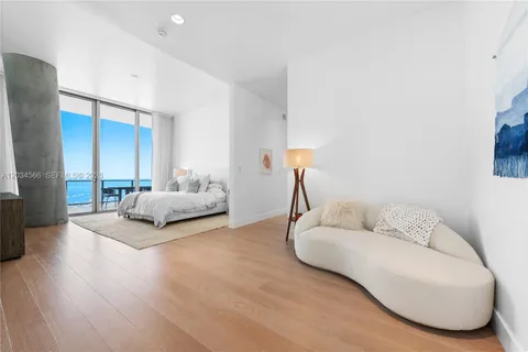 a spacious bedroom with a bed and a couch