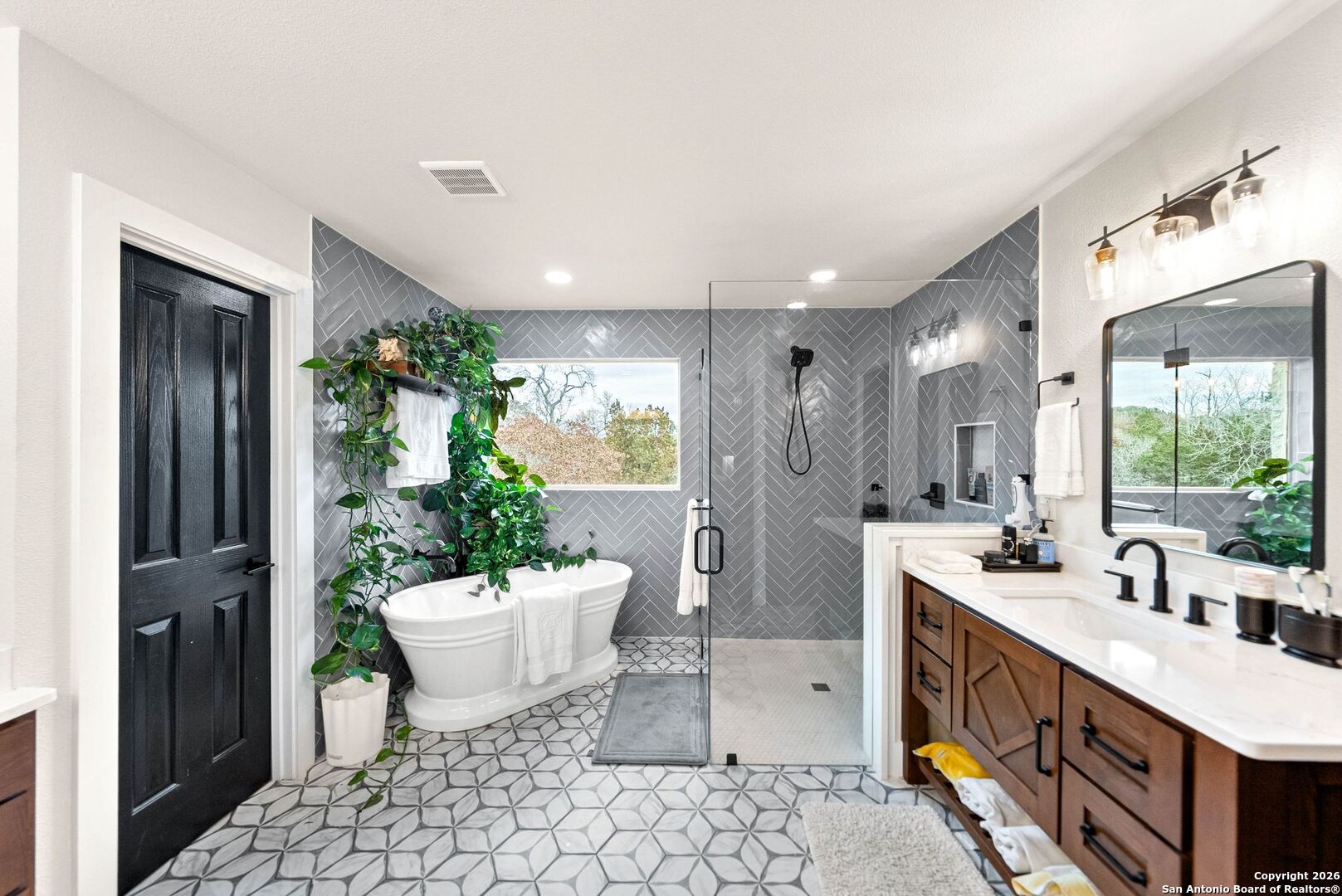 27150 Karsch Road Boerne, TX 78006 - Photo 27 of 79 a spacious bathroom with a double vanity sink a large mirror and a shower
