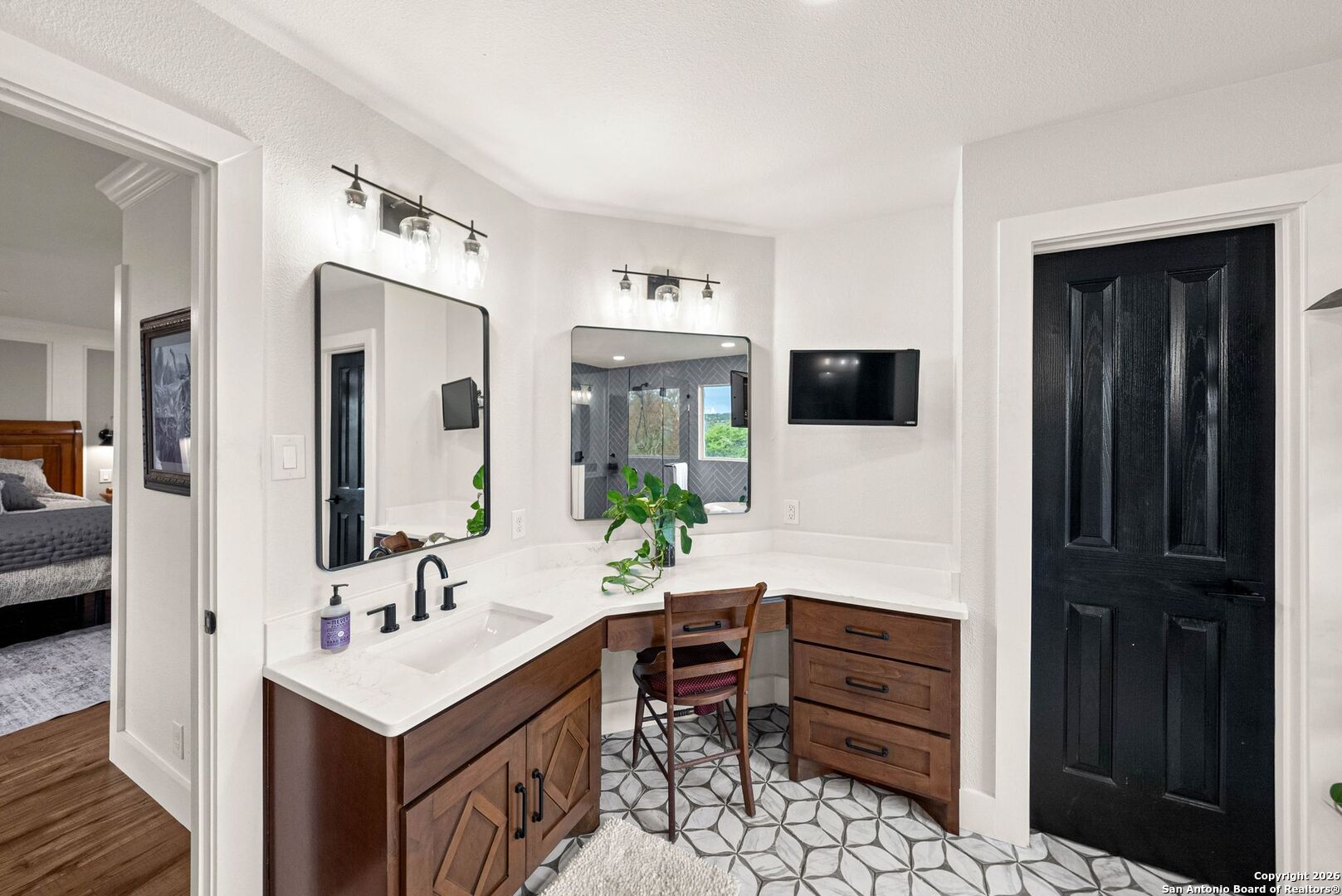 27150 Karsch Road Boerne, TX 78006 - Photo 28 of 79 a bathroom with a sink a large mirror and a shower