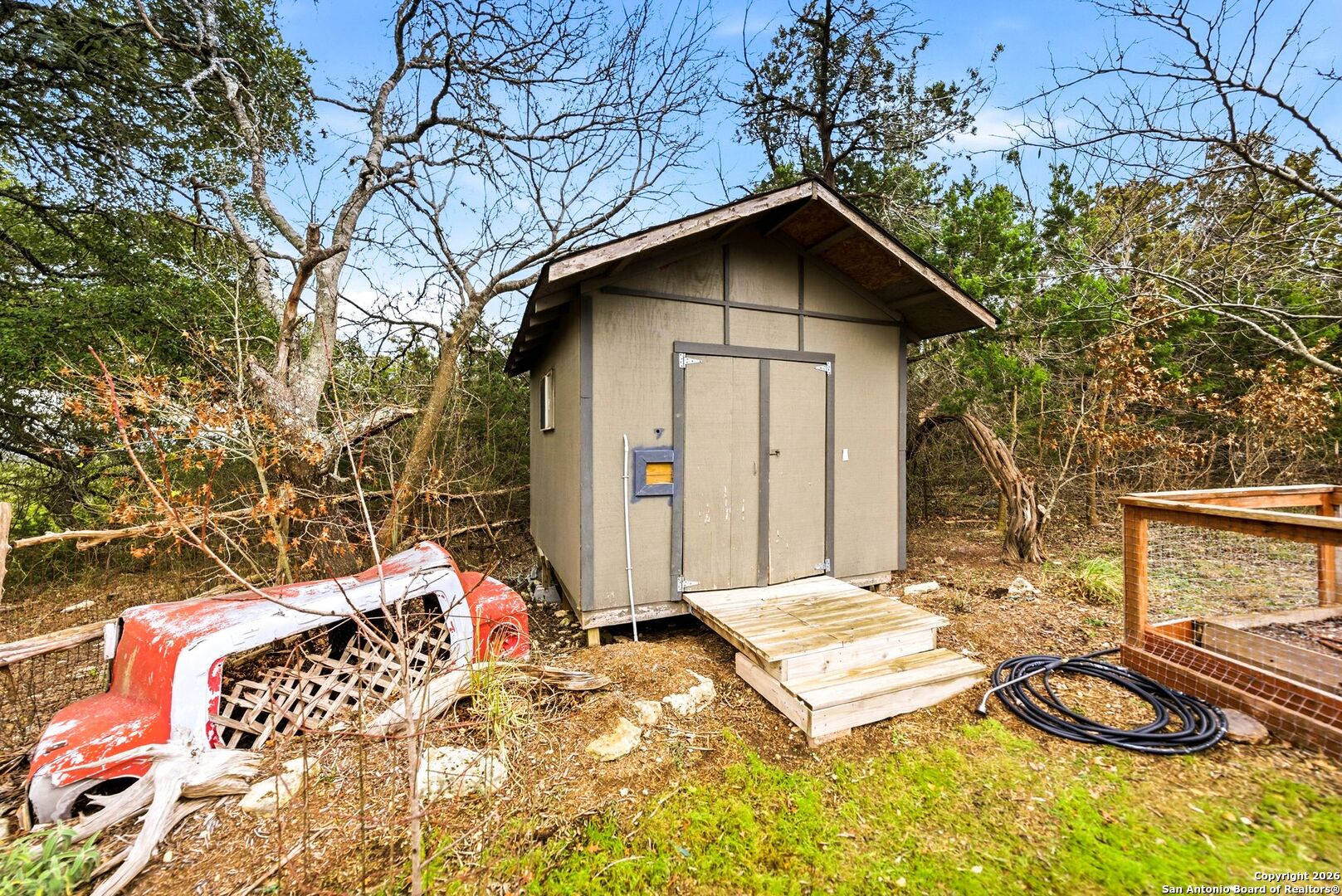 27150 Karsch Road Boerne, TX 78006 - Photo 54 of 79 a wooden bench sitting in front of a house