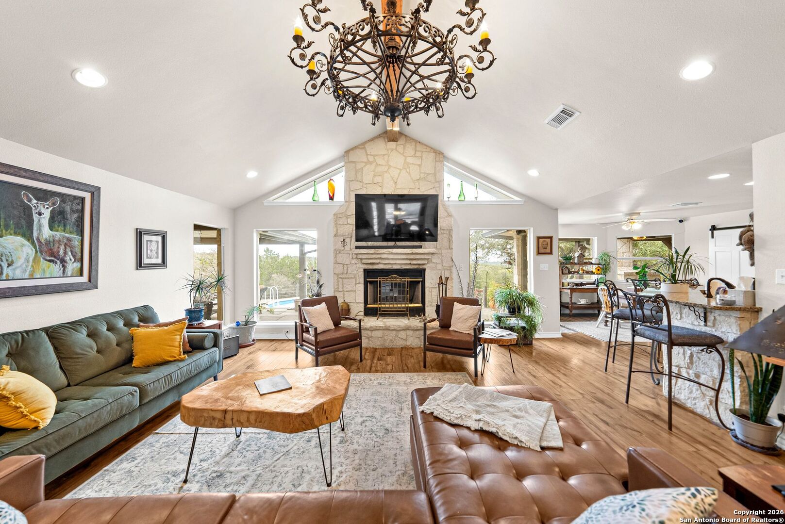 27150 Karsch Road Boerne, TX 78006 - Photo 8 of 79 a living room with furniture a fireplace and a chandelier