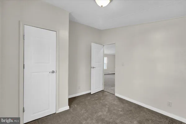 an empty room with closet area