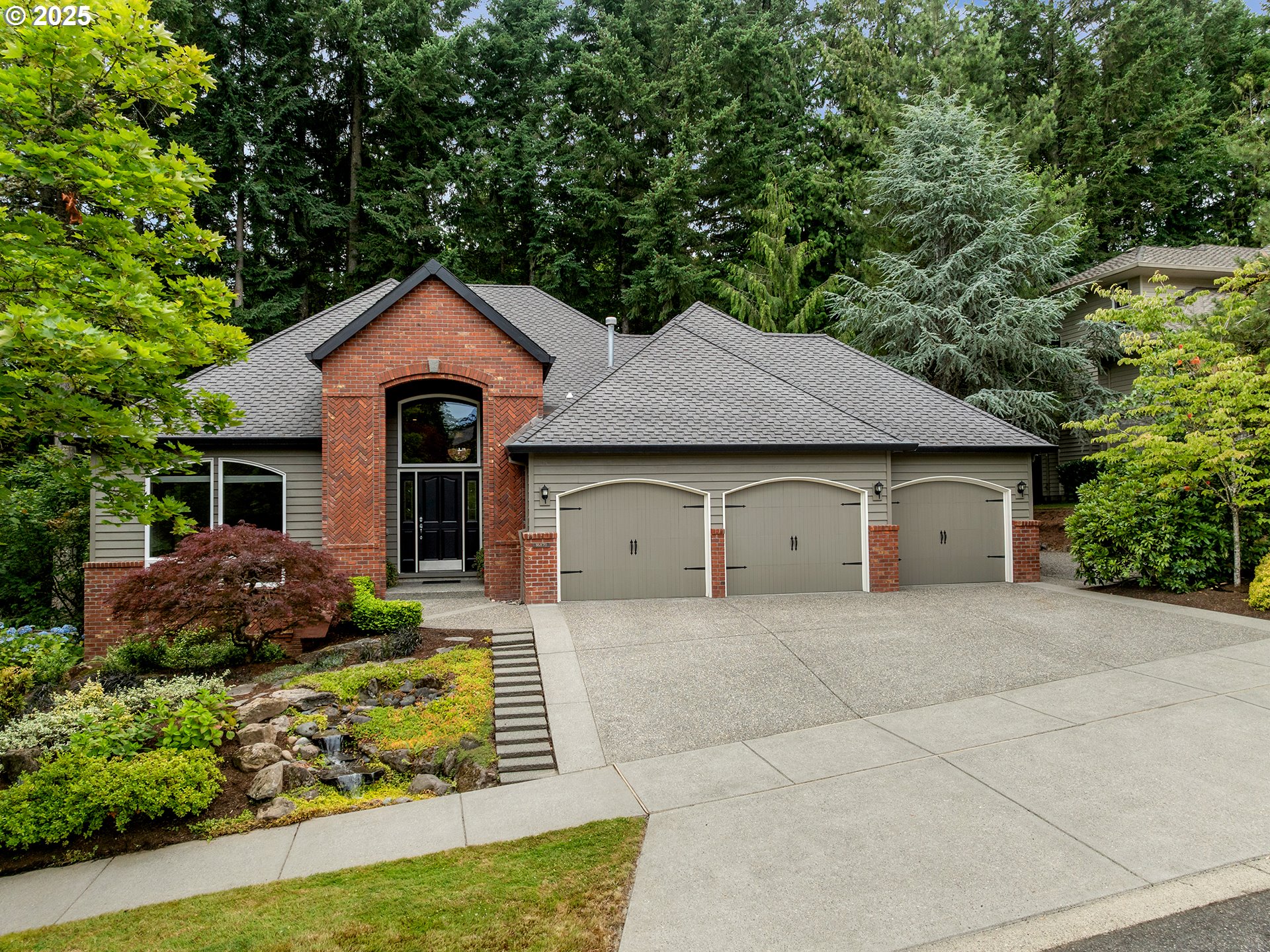 16870 Southwest Red Rock Way Beaverton, OR 97007 - Photo 1 of 45 a front view of a house with a yard and garage