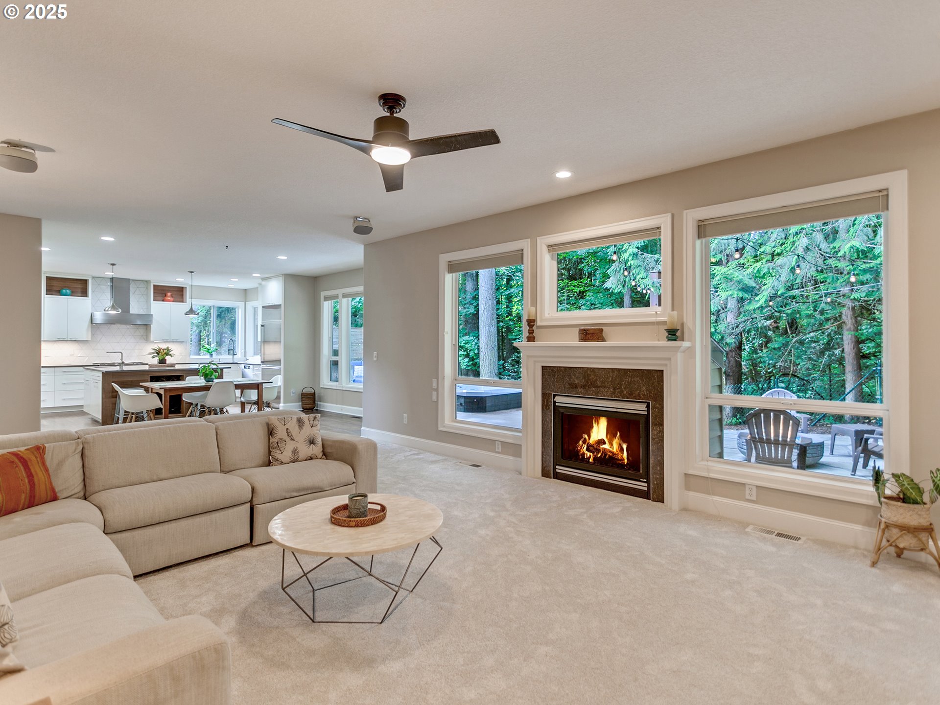 16870 Southwest Red Rock Way Beaverton, OR 97007 - Photo 11 of 45 a living room with furniture a fireplace and a large window