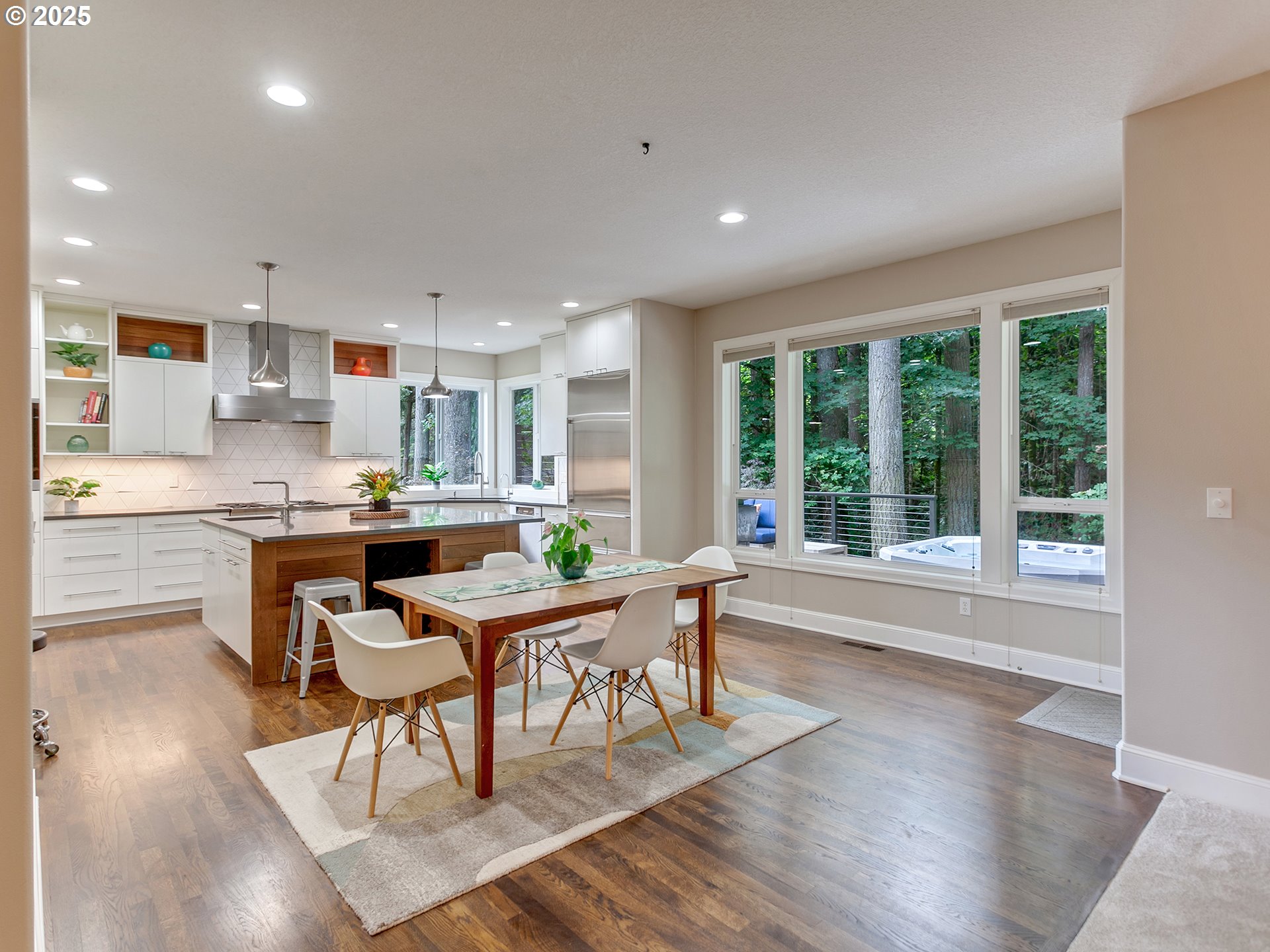 16870 Southwest Red Rock Way Beaverton, OR 97007 - Photo 12 of 45 a open dining room with kitchen island stainless steel appliances wooden floor and a large window