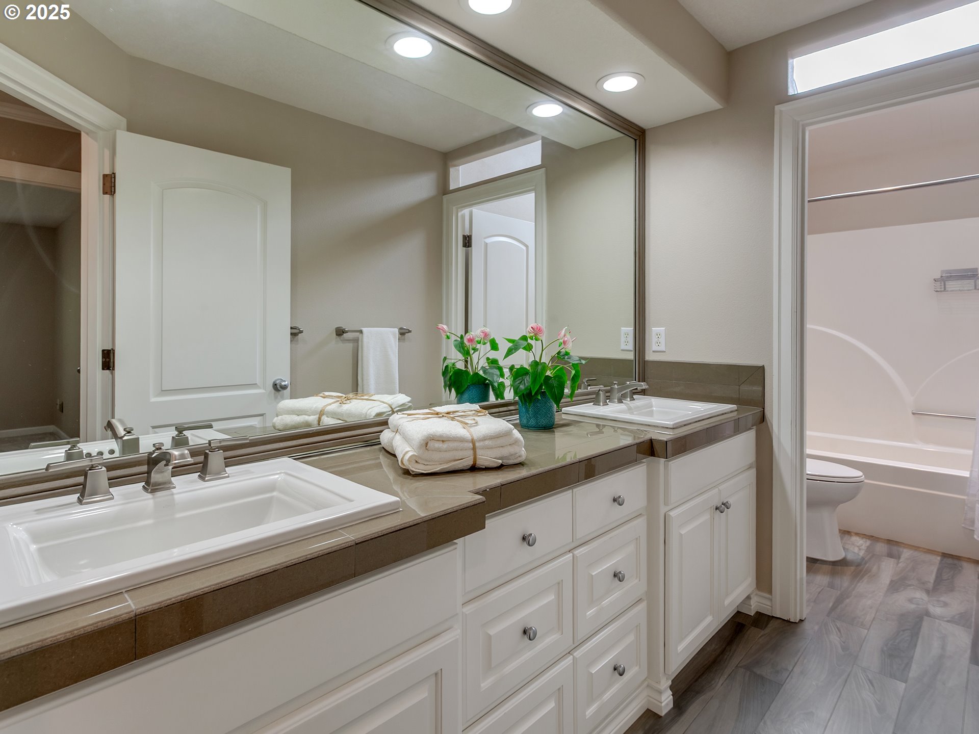 16870 Southwest Red Rock Way Beaverton, OR 97007 - Photo 25 of 45 a bathroom with double vanity sinks a vanity and a large mirror