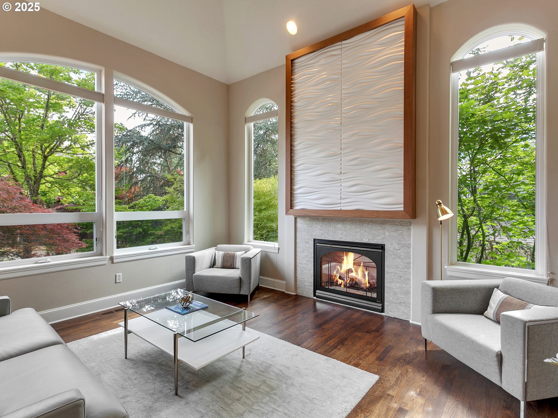 16870 Southwest Red Rock Way Beaverton, OR 97007 - Photo 5 of 45 a living room with furniture a fireplace and floor to ceiling windows