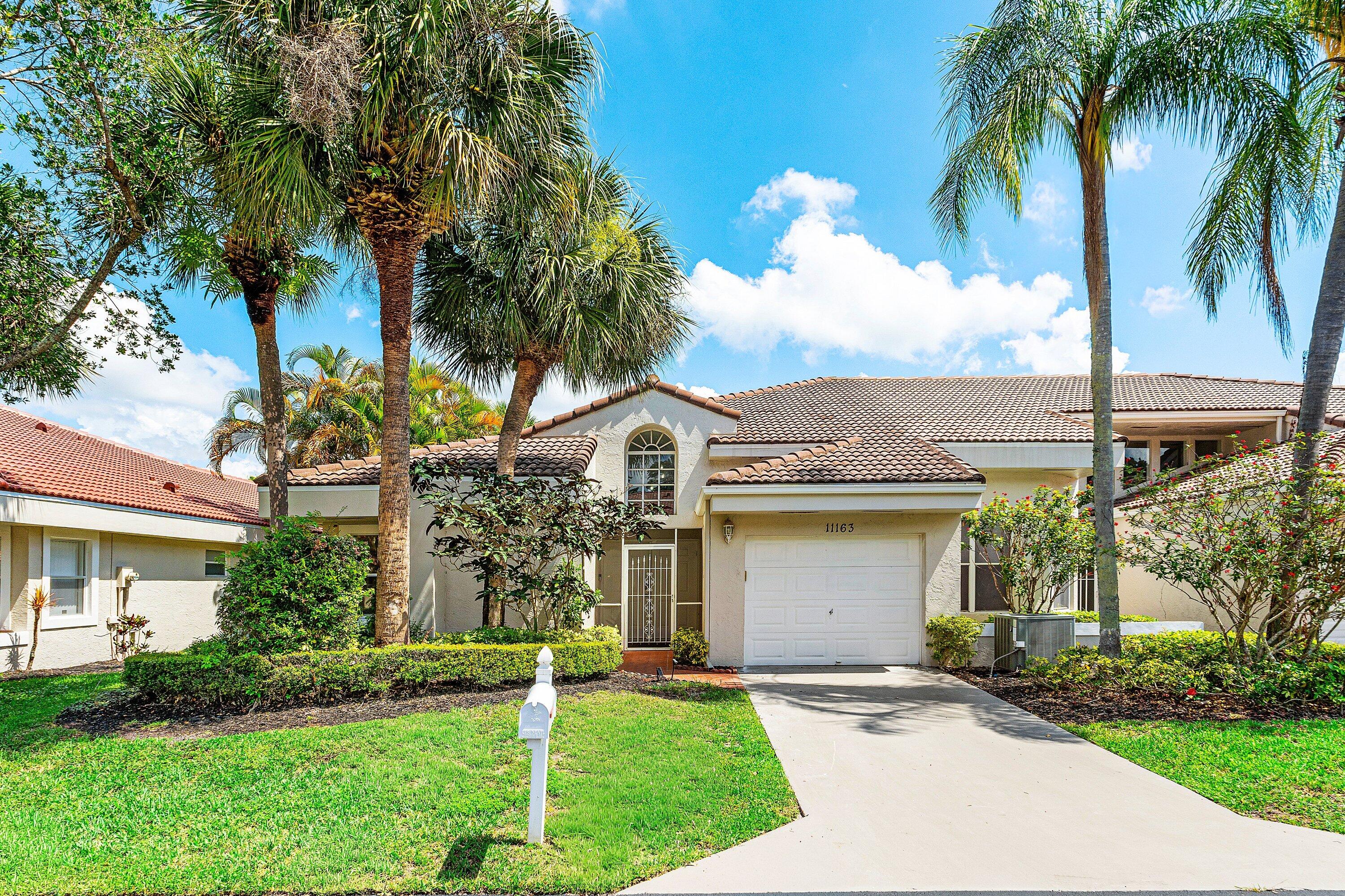 11163 180th Court South Boca Raton, FL 33498 - Photo 22 of 22 front view of house with a yard and palm trees