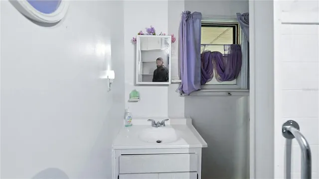 a bathroom with a sink and mirror