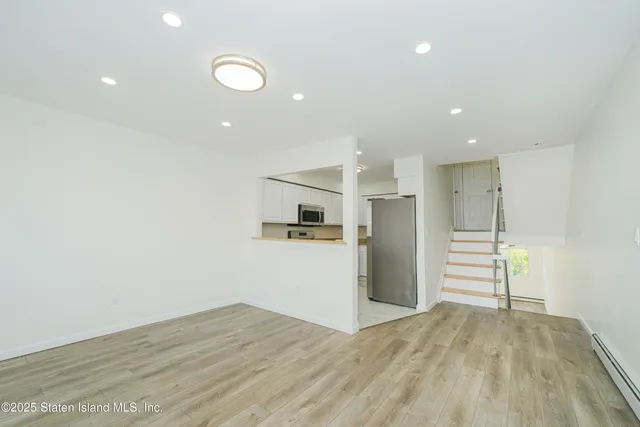 a view of a kitchen with a sink and a refrigerator