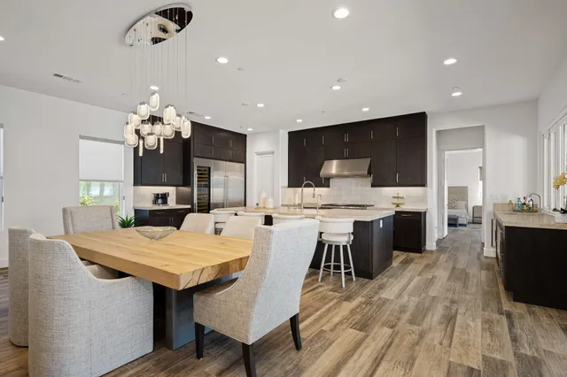 a large kitchen with a table and chairs