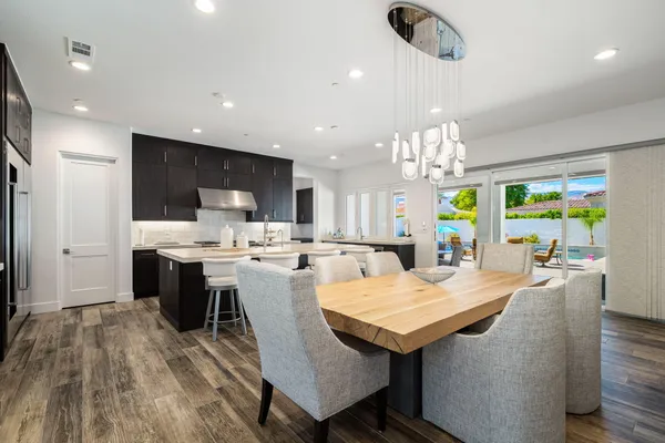 a large kitchen with a table and chairs