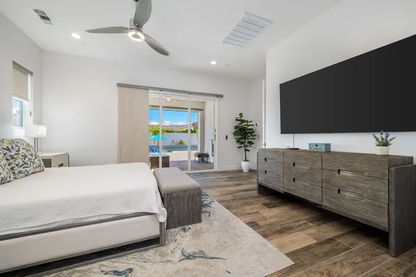 a spacious bathroom with a granite countertop sink a toilet a mirror and vanity