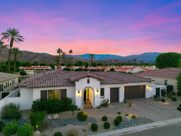 a view of a patio with a table and chairs under an umbrella