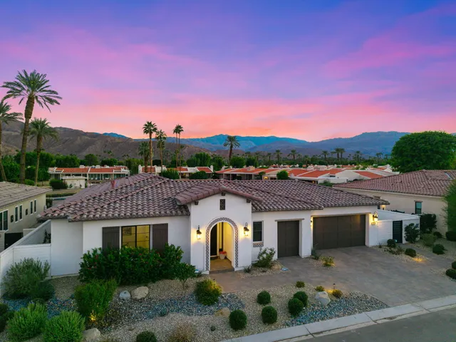a view of a patio with a table and chairs under an umbrella