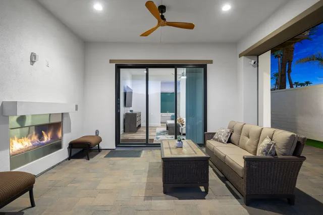 a living room with furniture and a gym machine