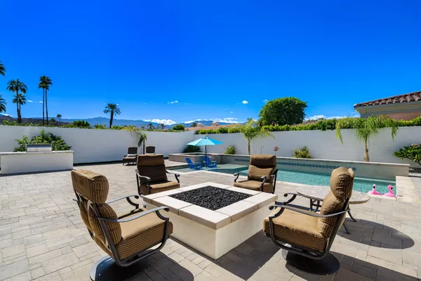 a view of a patio with couches and potted plants