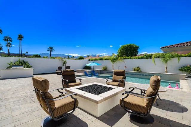 a view of a patio with couches and potted plants