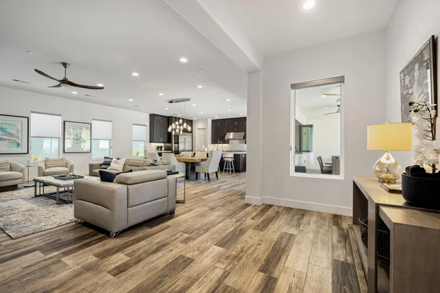 a living room with furniture and a wooden floor