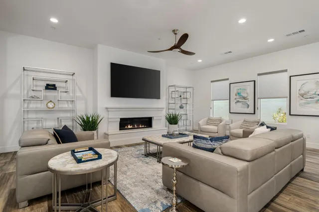 a living room with furniture a fireplace and a flat screen tv