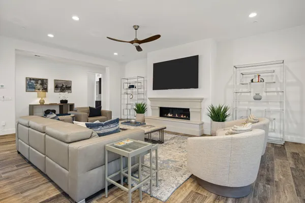 a living room with furniture a fireplace and a flat screen tv