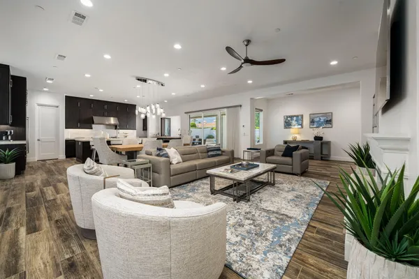 a living room with fireplace furniture and a potted plant