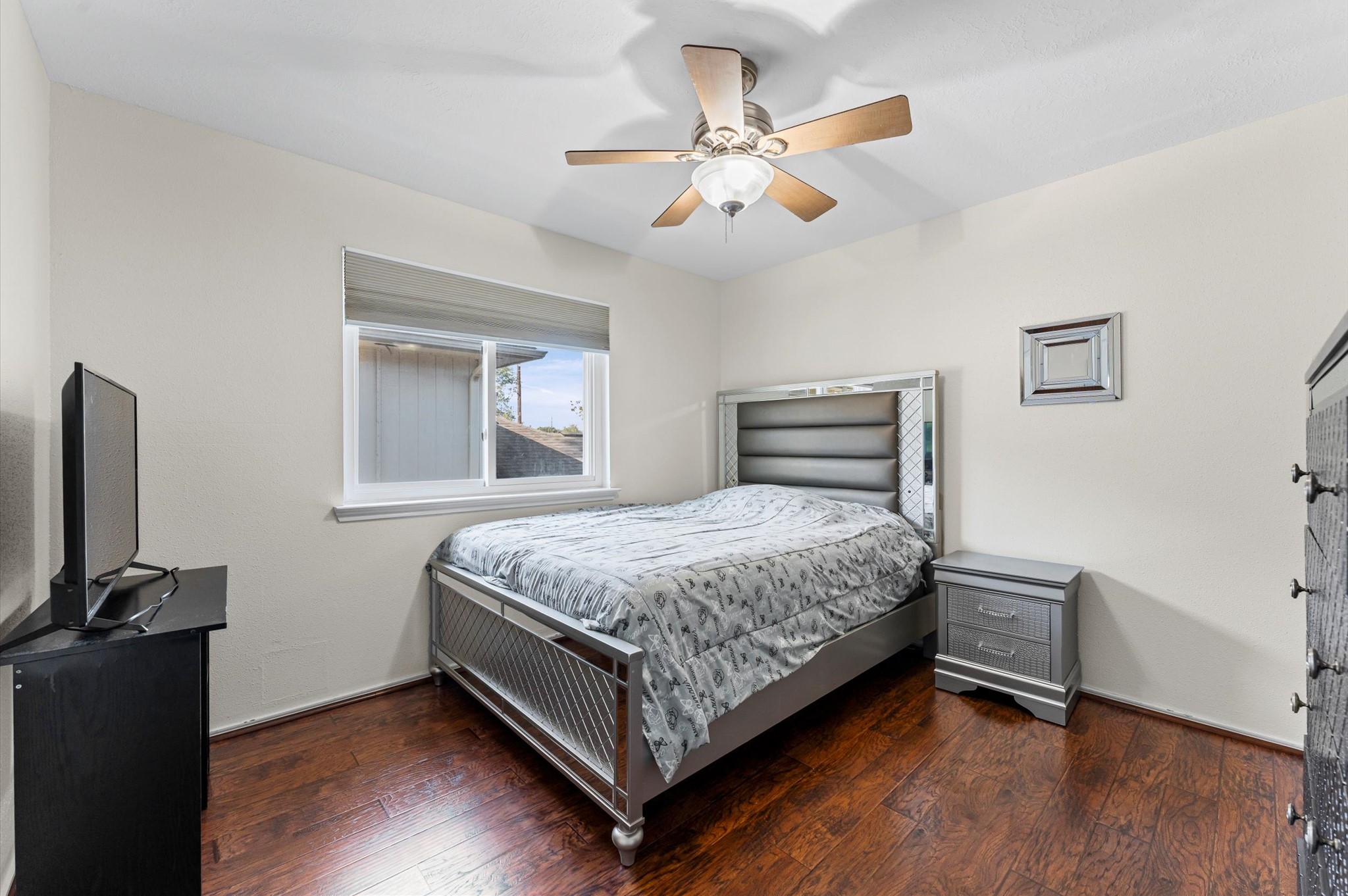 16506 Crossfield Drive Houston, TX 77095 - Photo 13 of 20 a bedroom with a bed and a flat screen tv