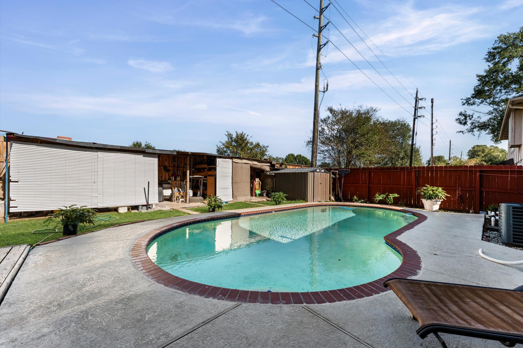 16506 Crossfield Drive Houston, TX 77095 - Photo 19 of 20 a view of a swimming pool with a chairs and table in patio