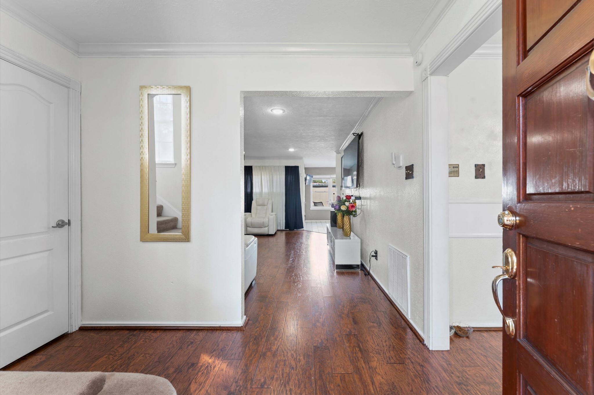 16506 Crossfield Drive Houston, TX 77095 - Photo 3 of 20 a view of a hallway with wooden floor and a living room