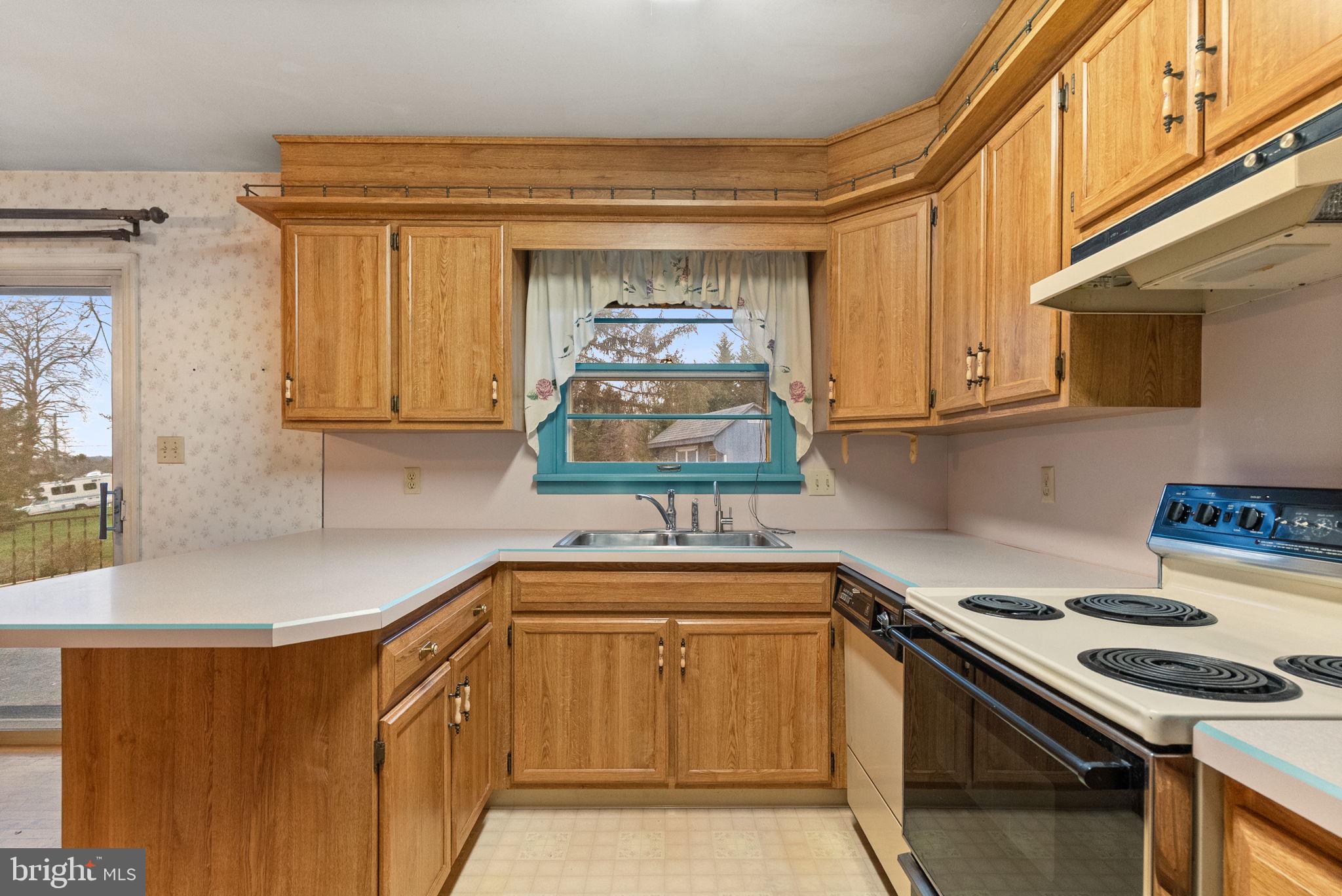 180 Delp Road Lancaster, PA 17601 - Photo 11 of 40 a kitchen with stainless steel appliances granite countertop a sink and a stove