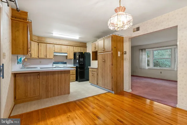 a kitchen with stainless steel appliances granite countertop a refrigerator and a stove