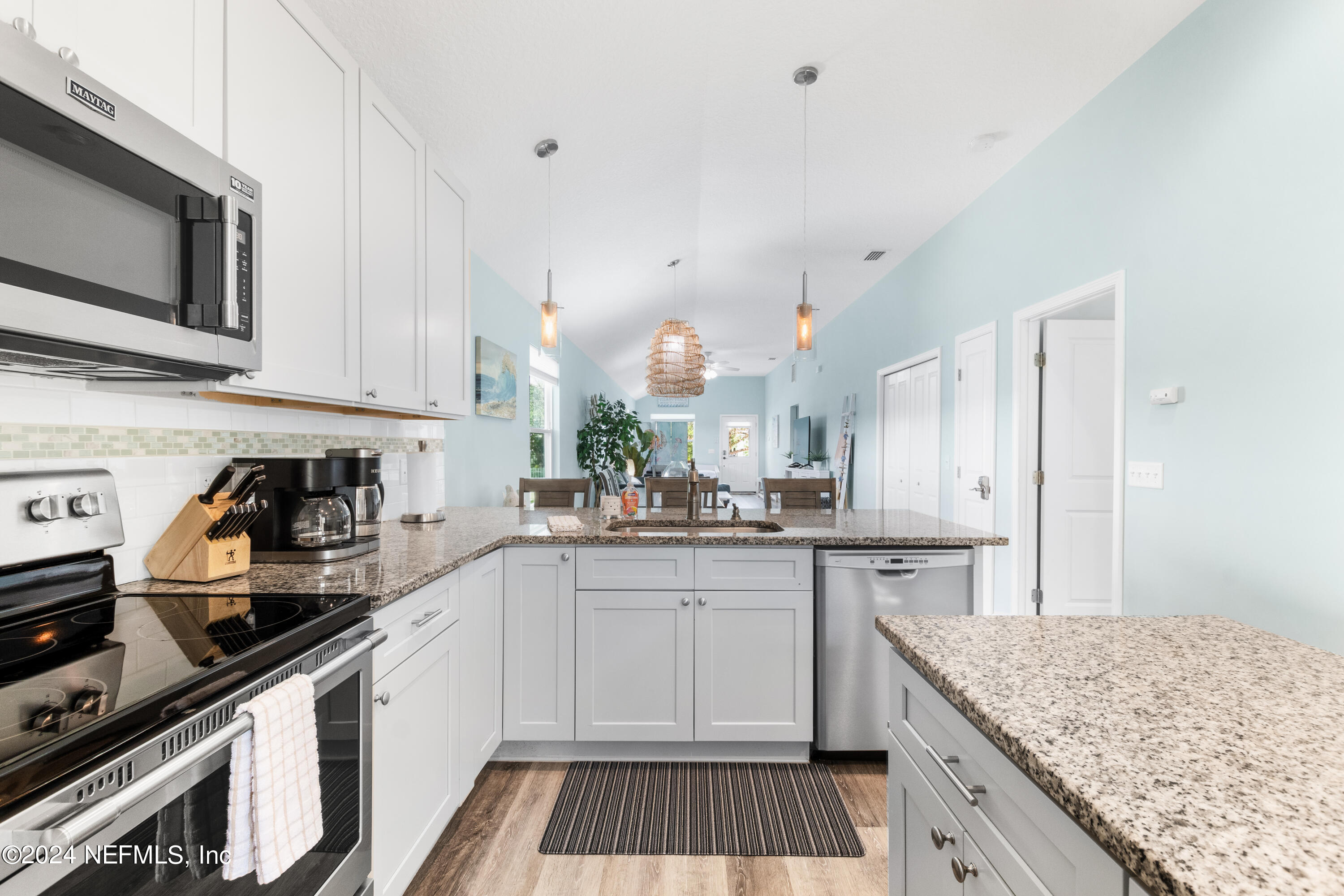 603 Boating Club Road St. Augustine, FL 32084 - Photo 12 of 32 a kitchen with a sink stove top oven and cabinets