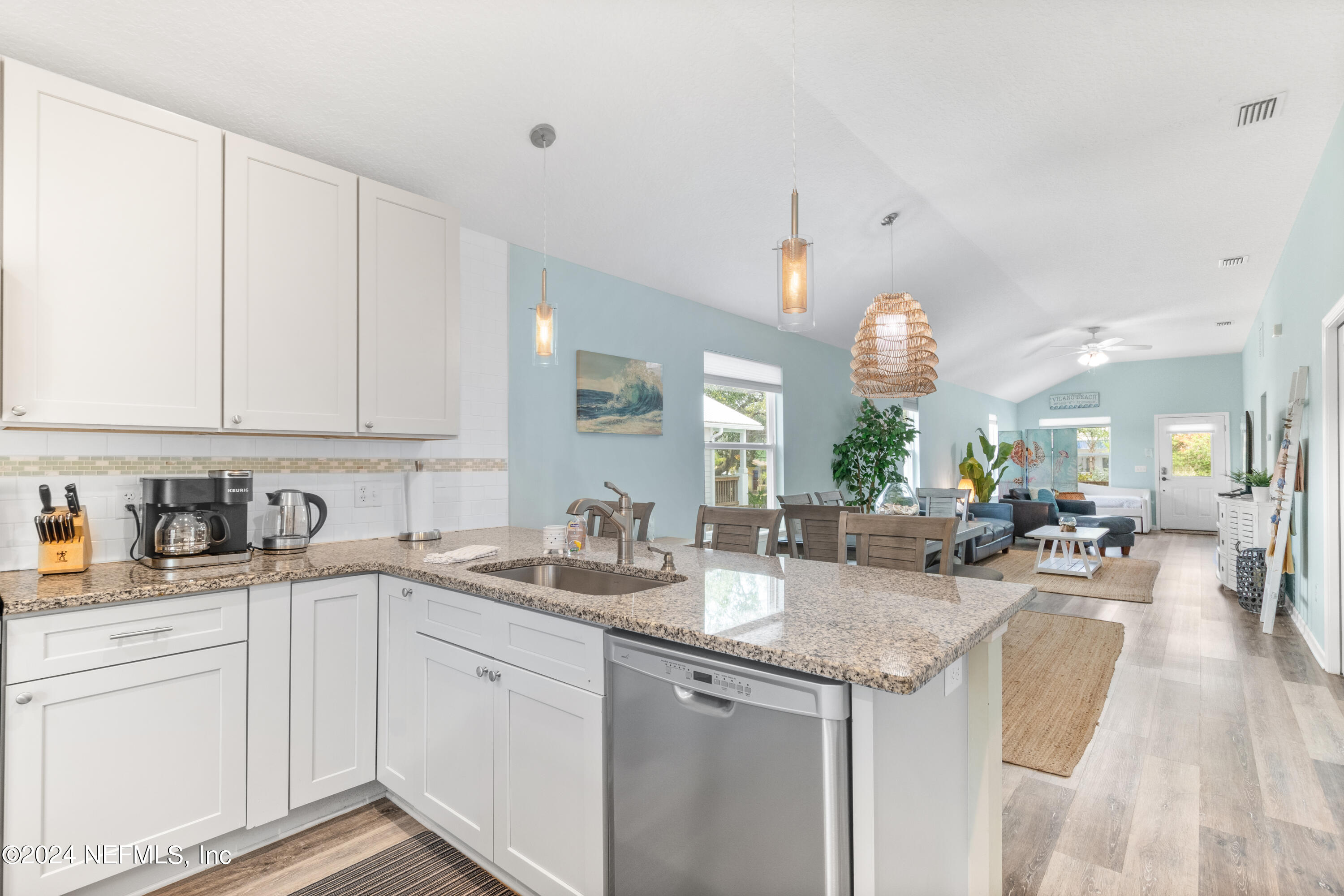 603 Boating Club Road St. Augustine, FL 32084 - Photo 15 of 32 a kitchen with sink cabinets and living room view