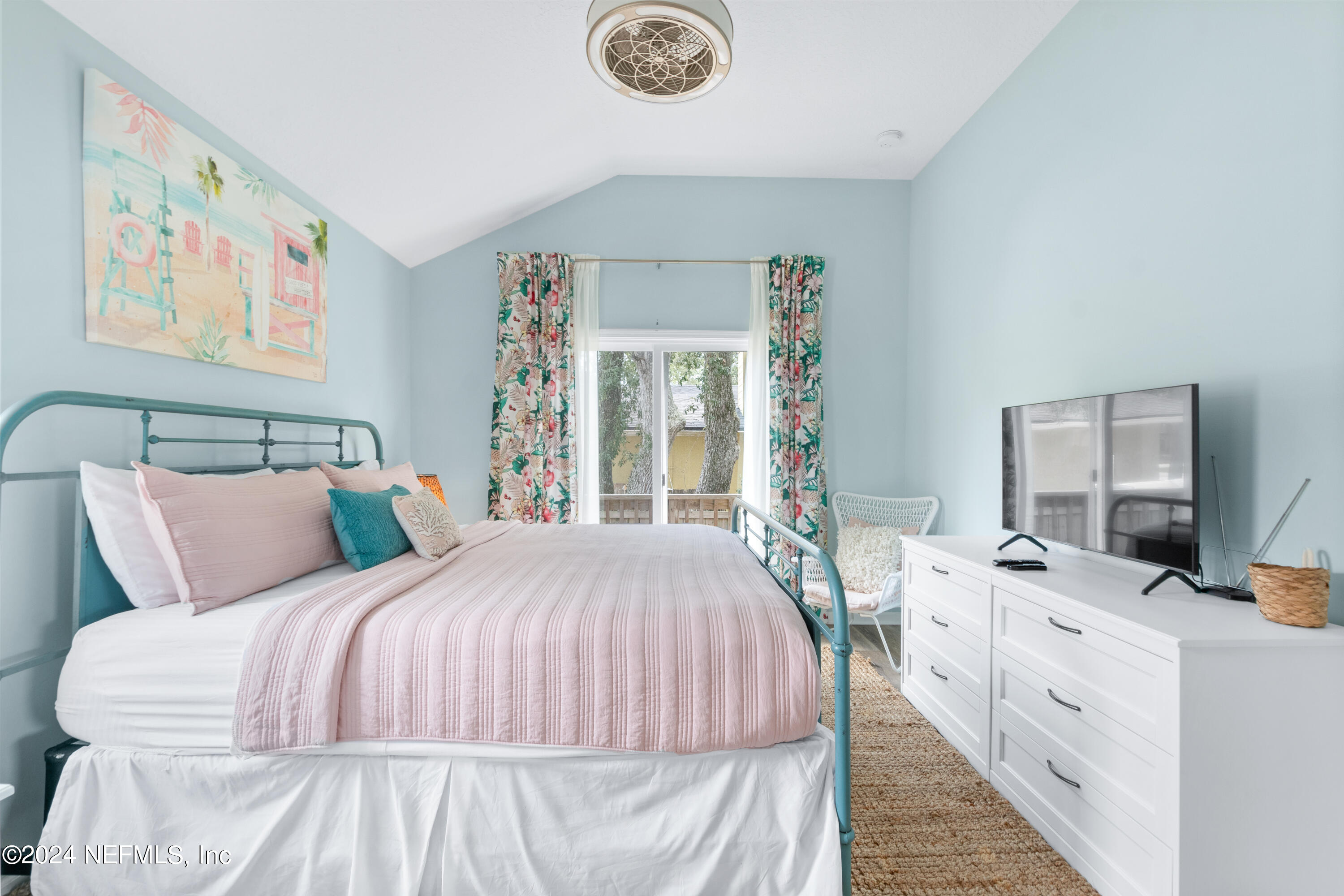603 Boating Club Road St. Augustine, FL 32084 - Photo 19 of 32 a bedroom with a bed and a large mirror on the dresser