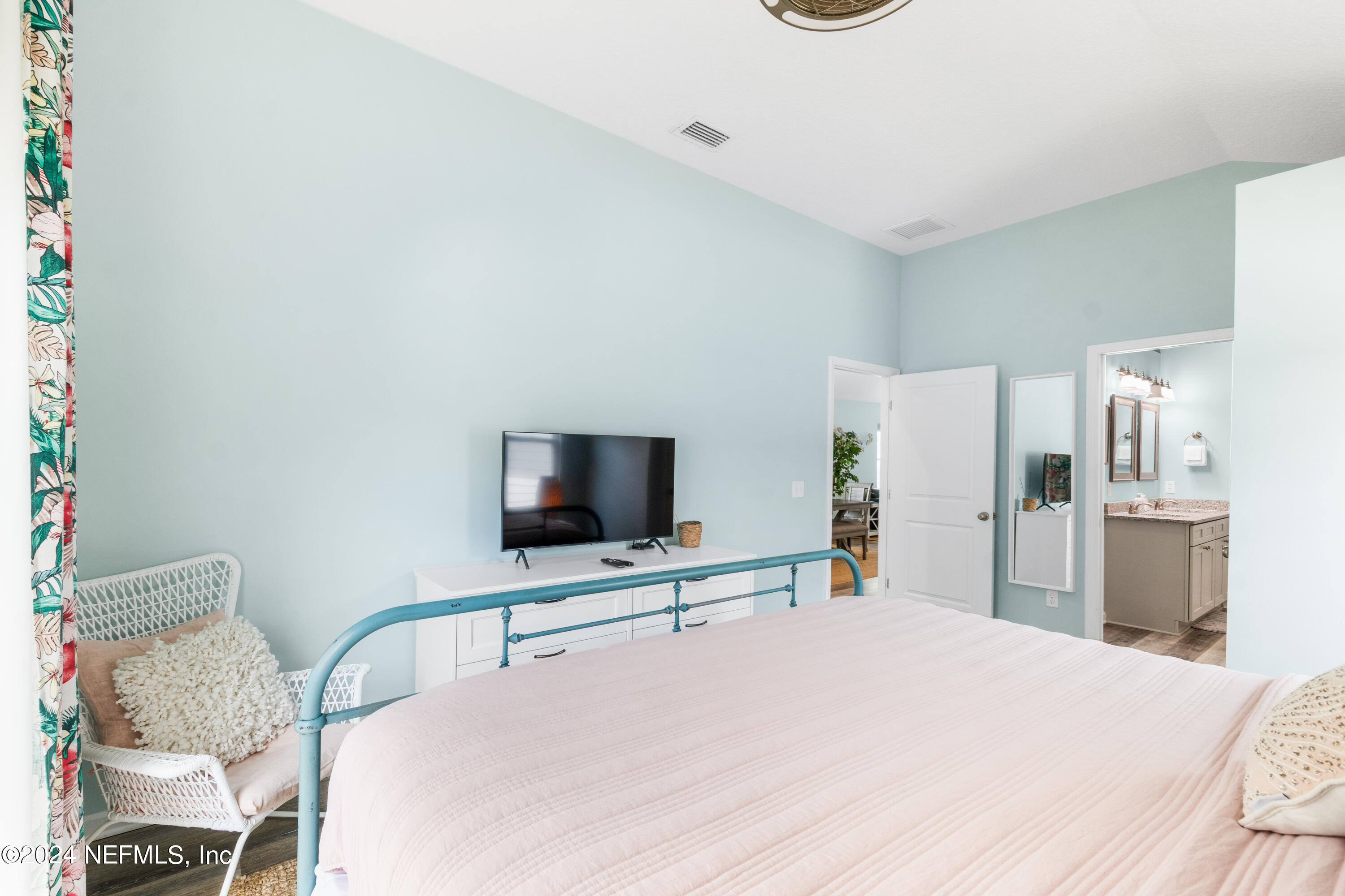603 Boating Club Road St. Augustine, FL 32084 - Photo 20 of 32 a bedroom with a bed and a flat screen tv