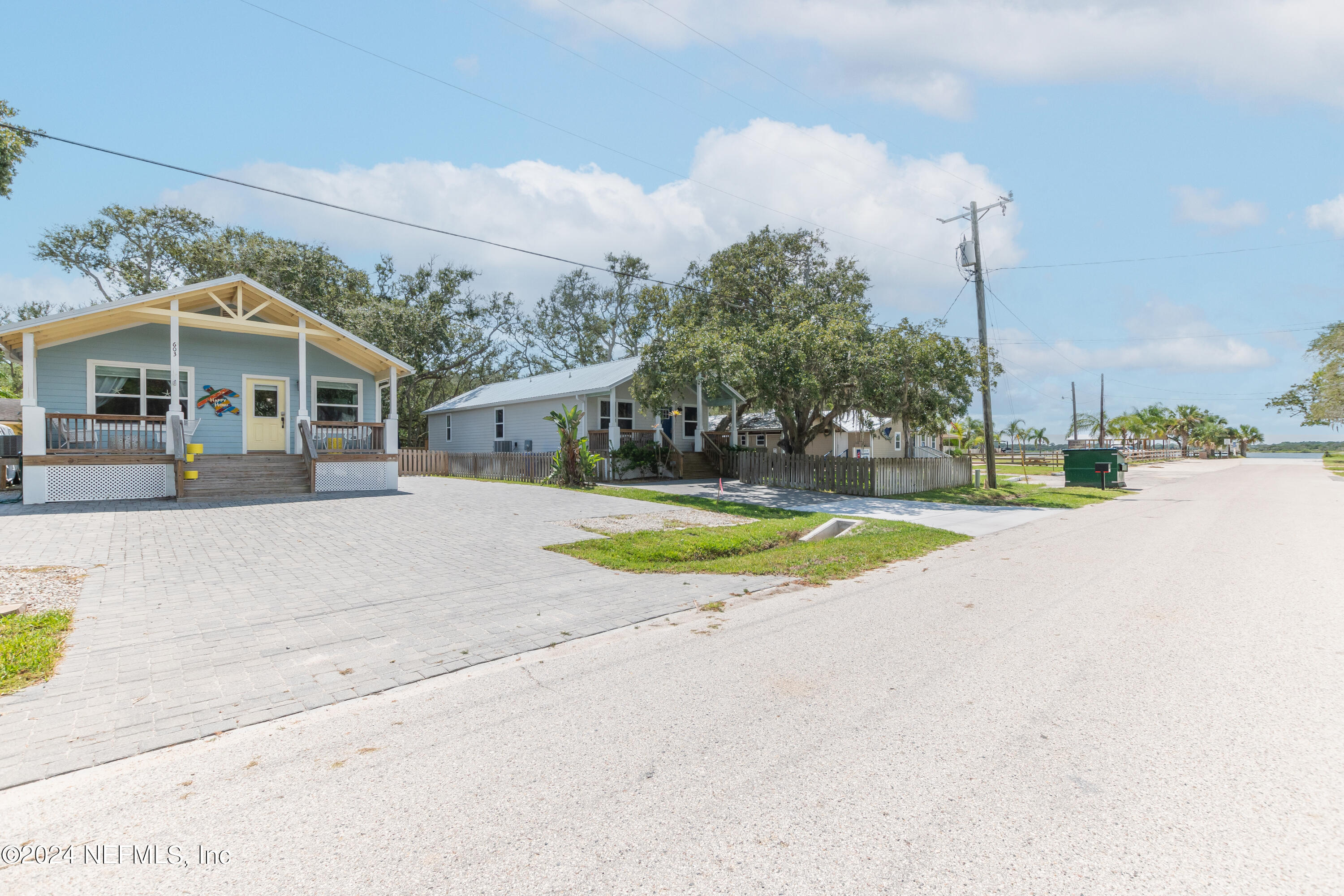 603 Boating Club Road St. Augustine, FL 32084 - Photo 2 of 32 a view of a white house with a yard next to a road