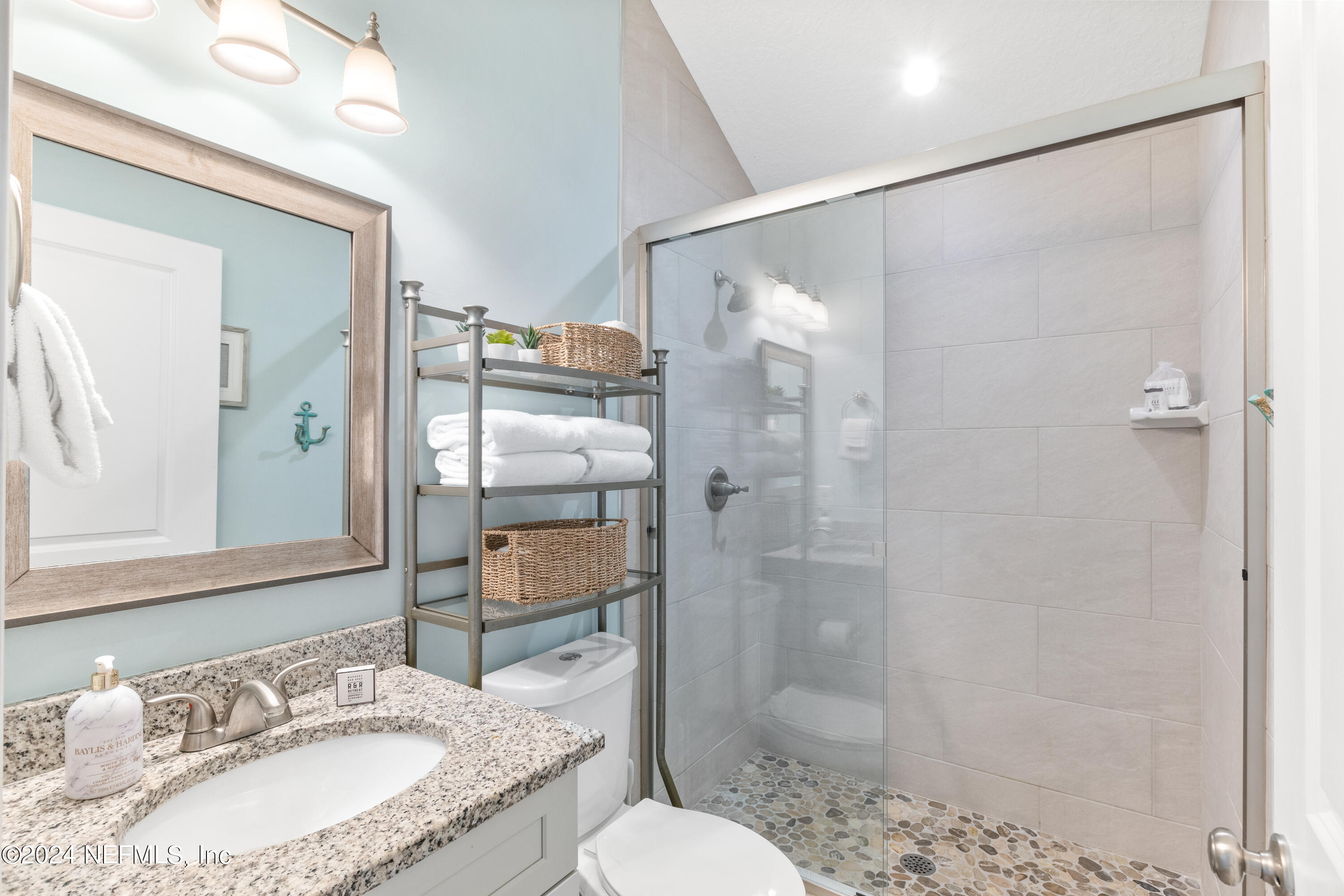 603 Boating Club Road St. Augustine, FL 32084 - Photo 27 of 32 a bathroom with a granite countertop sink toilet and shower