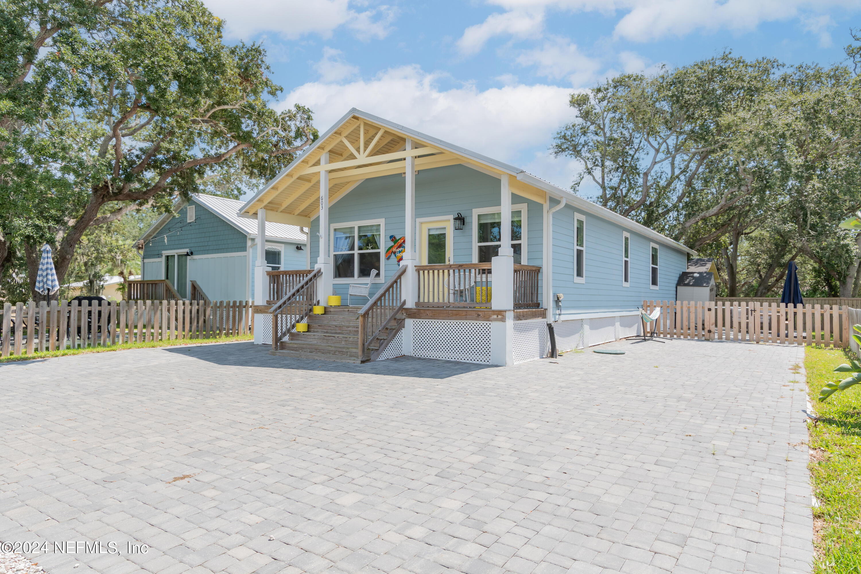 603 Boating Club Road St. Augustine, FL 32084 - Photo 3 of 32 a view of a house with a yard and large trees