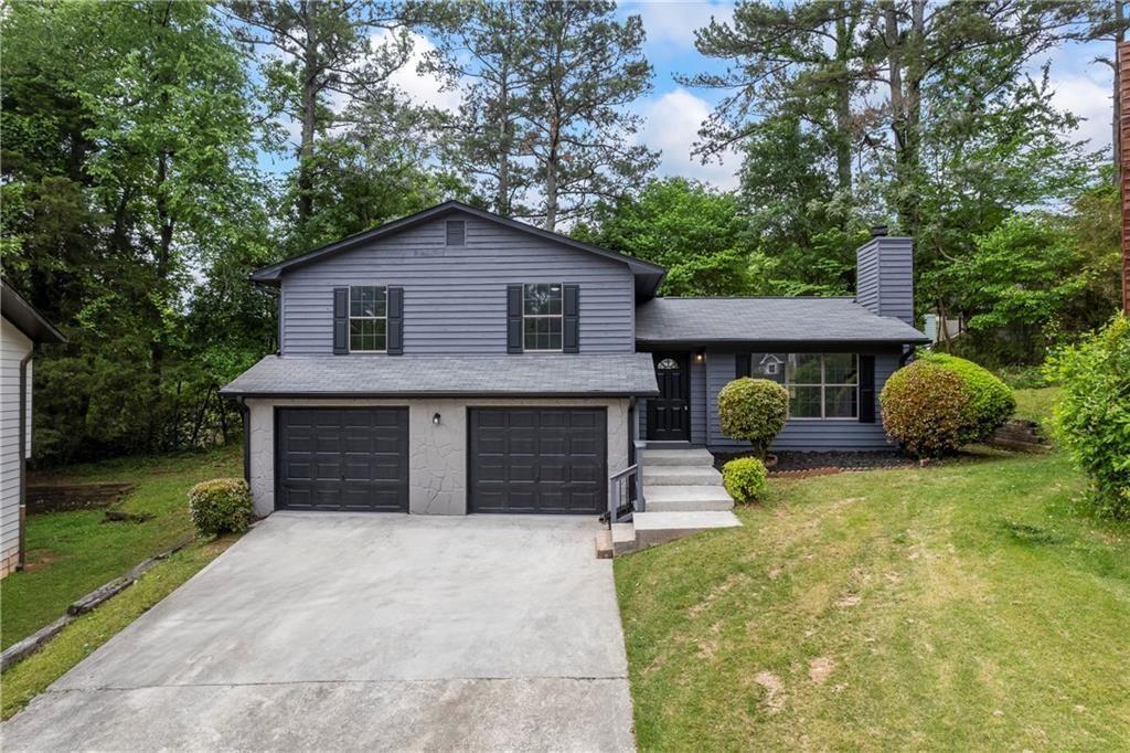 2246 Hightrail Court Lithonia, GA 30058 - Photo 1 of 1 a front view of a house with a yard and garage