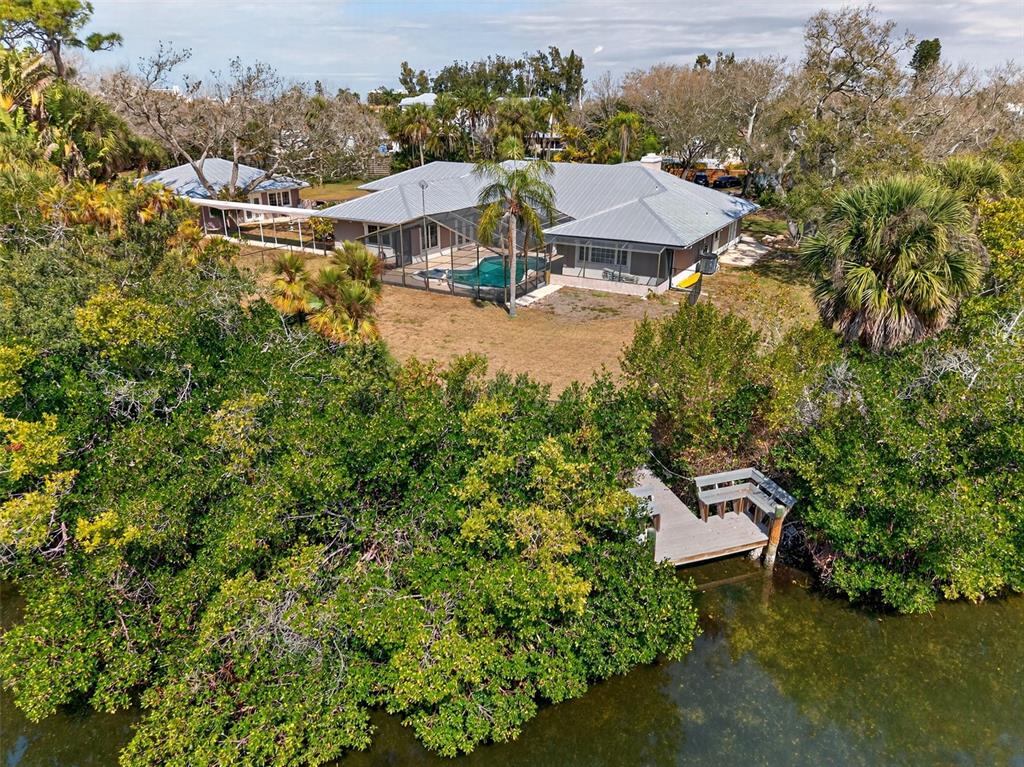 7108 Midnight Pass Road Sarasota, FL 34242 - Photo 64 of 83 a view of a house with a yard and sitting area