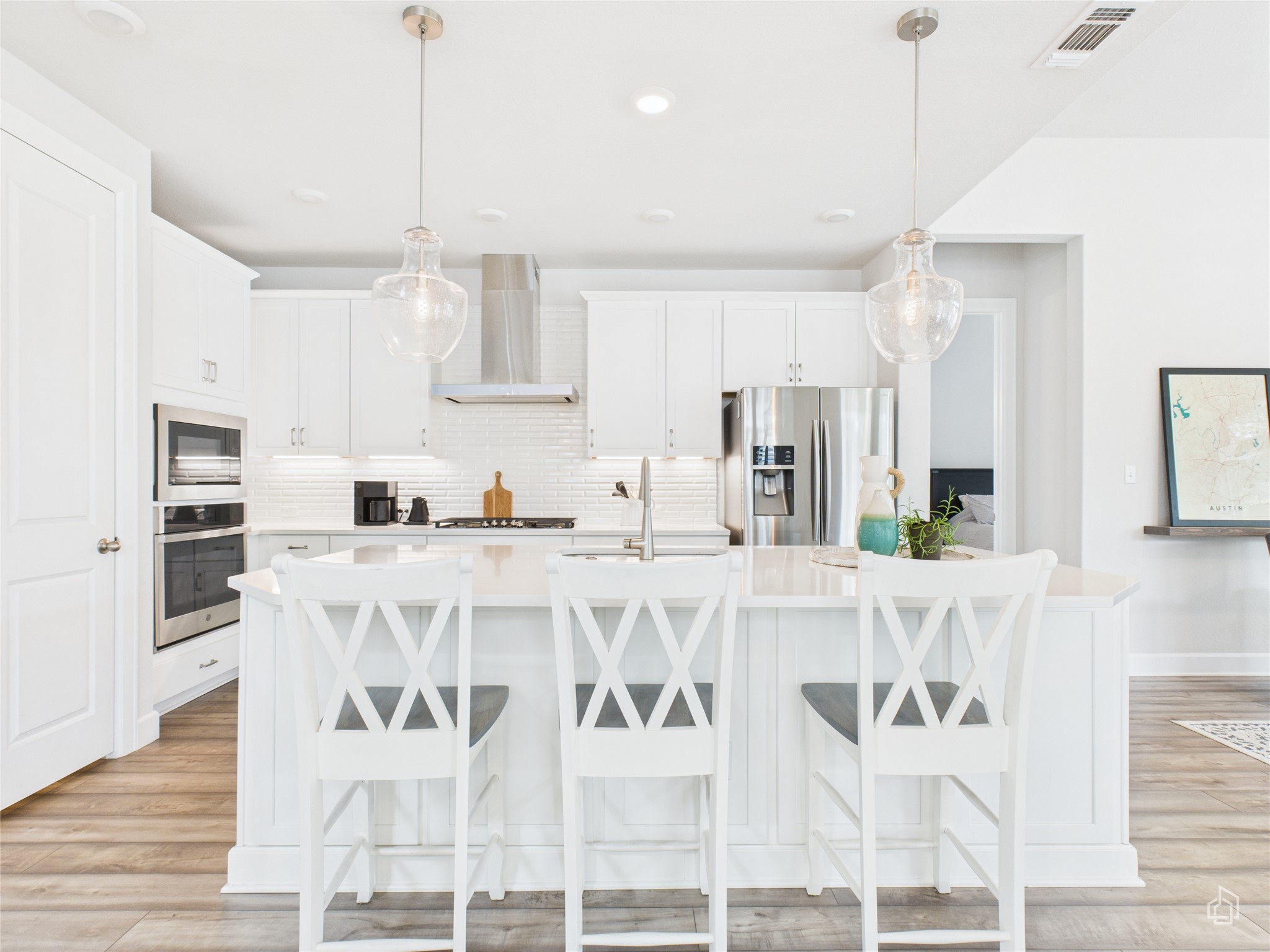 378 Moonlit Stream Pass Dripping Springs, TX 78620 - Photo 16 of 38 a kitchen with stainless steel appliances kitchen island granite countertop a dining table chairs and white cabinets