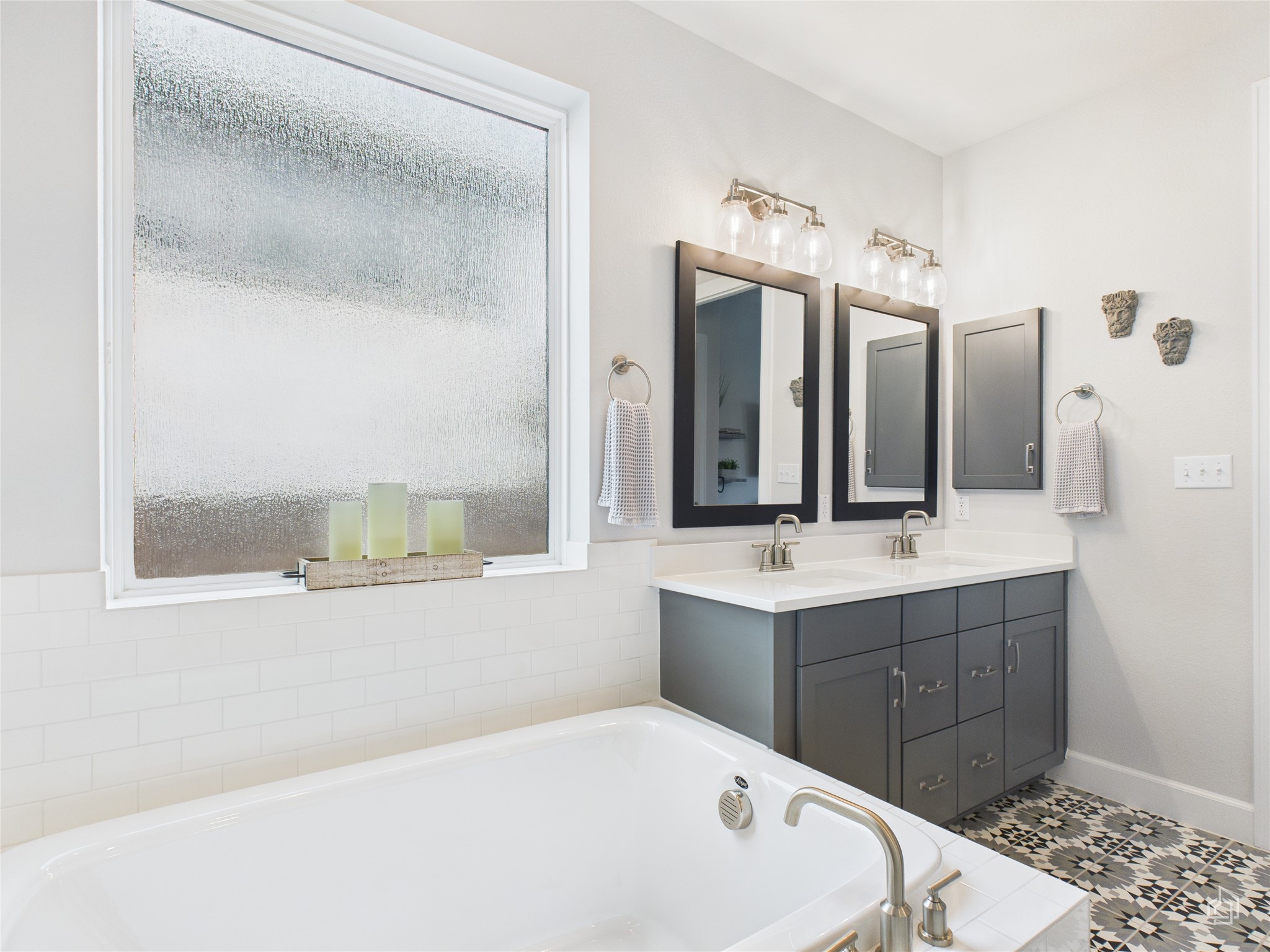 378 Moonlit Stream Pass Dripping Springs, TX 78620 - Photo 27 of 38 a bathroom with a tub sink and mirror