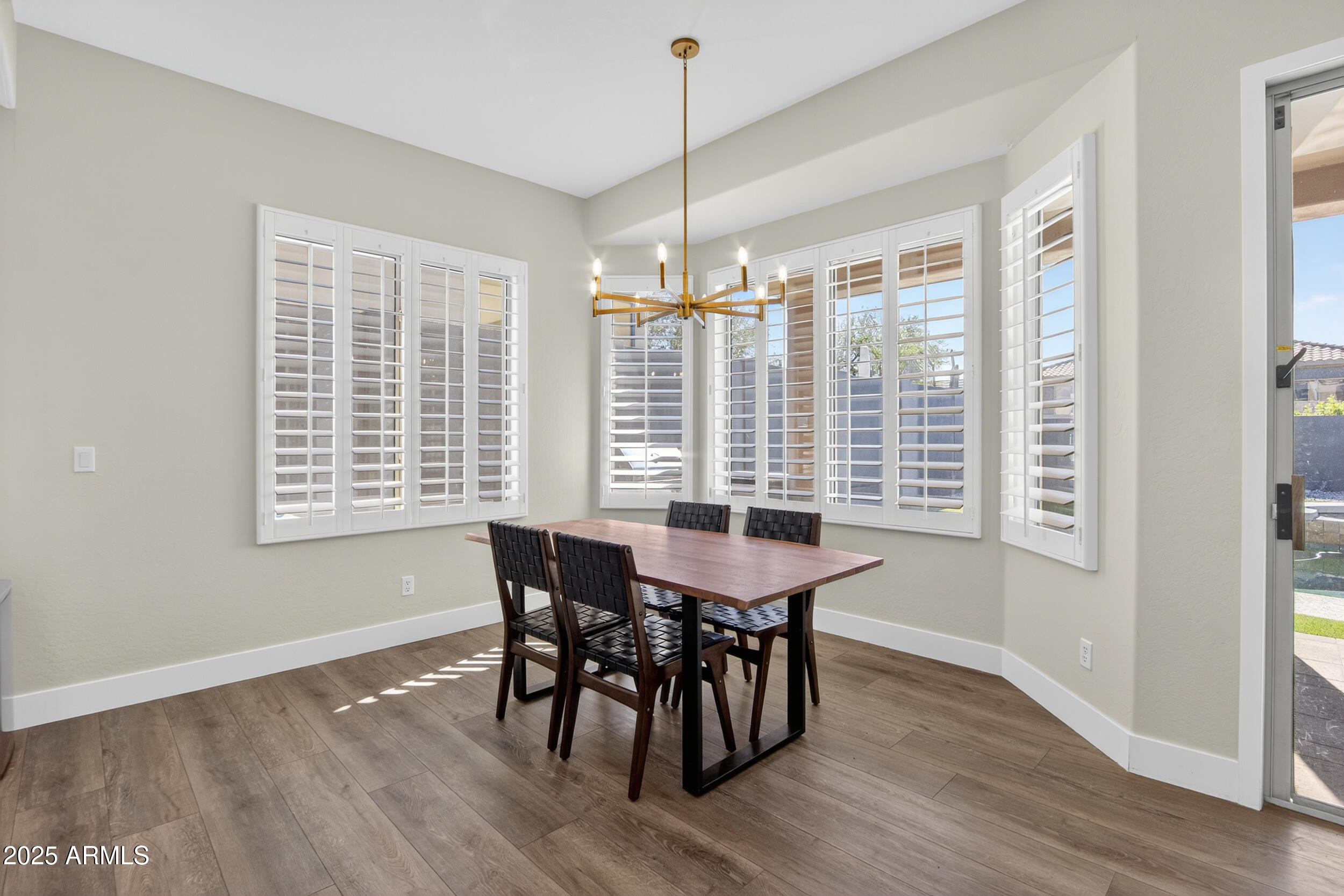10587 East Sheena Drive Scottsdale, AZ 85255 - Photo 13 of 56 a view of a dining room with furniture window and wooden floor